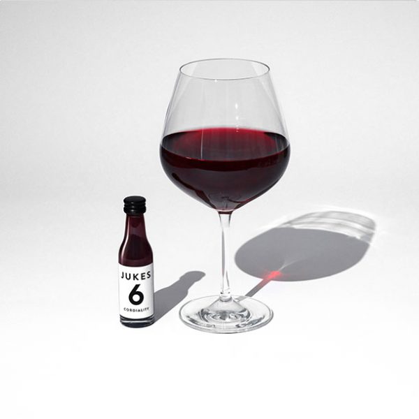 Matthew Jukes RedWine No.6 beside a glass